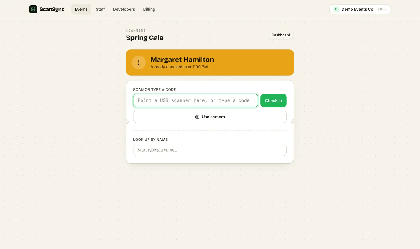 Web scan page showing an amber Already checked in result, a code input box and a Use camera button